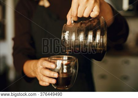 Person Pouring Fresh Aromatic Coffee From Glass Kettle In Cup. Alternative Coffee Brewing, V60. Prof
