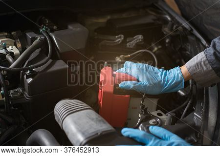 Car Battery Care, Mechanic Checking Battery, Close-up.
