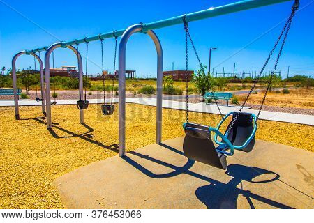 Swing Sets On Playground In Free Public Park