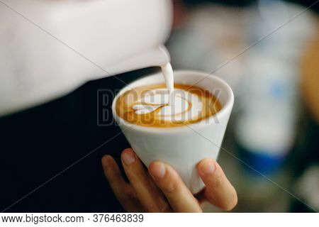 Professional Barista Pouring Latte Foame Over Coffee, Espresso And Creating A Perfect Cappuccino