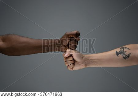 Greeting Fist Bump. Racial Tolerance. Respect Social Unity. African And Caucasian Hands Gesturing On