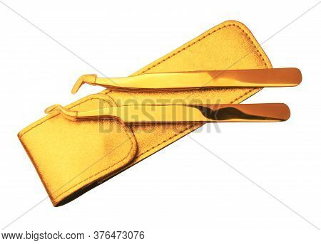 Golden Tool For Artificial Eyelashes On A White Background