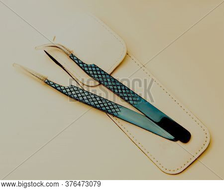 Blue Metal Tool For Artificial Eyelashes On A White Background