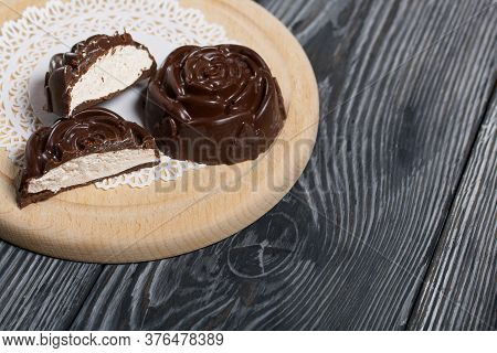 A Chocolate Marshmallow Made In The Shape Of A Rose Lies On A White Napkin. One Marshmallow Is Cut I