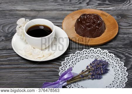 A Cup Of Black Coffee On A Saucer And Zephyr In Chocolate Made In The Form Of A Rose. Nearby On A Wh