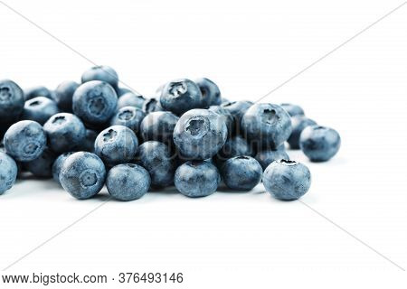 Tasty Blueberries Fruit Are Scattered On A White Background.