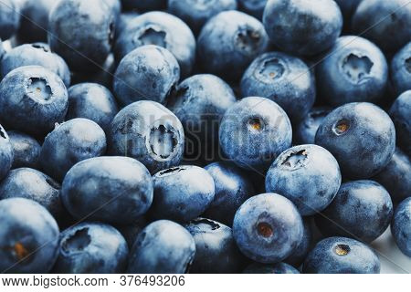 Tasty Blueberries Fruit Are Scattered On A White Background.