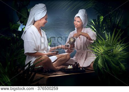 Portrait Of Young Beautiful Women Drinking Tea  In Spa Environment.