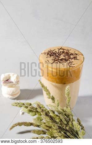 Korean Coffee Dalgon In A Glass Tall Glass. The Foam Is Sprinkled With Chocolate Chips. Dry Grass Sp