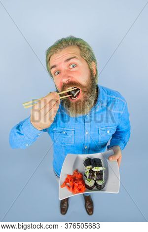 Japan. Sushi Delivery. Japanese Food. Sea Food. Bearded Man With Plate Of Sushiroll. Pickled Ginger.