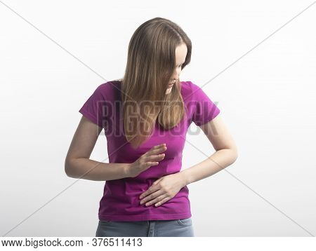 Caucasian Young Woman In Violet T-shirt With Stomachache During Menstruation Putting Her Hand On Ab 