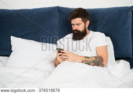 First Of All. Bearded Man Texting Sms In Bed. Hipster Send Message Using Smartphone. Mobile Message.