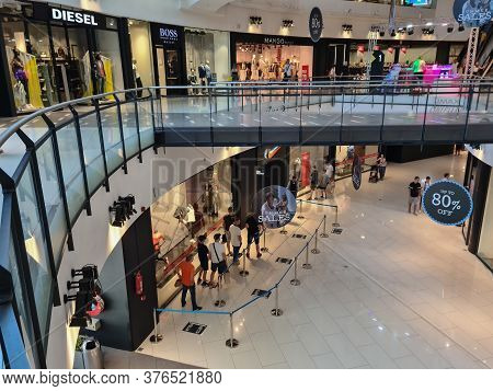 Thessaloniki, Greece - July 15 2020: Crowd Follows Social Distancing Covid-19 Measures In Mall. Unid