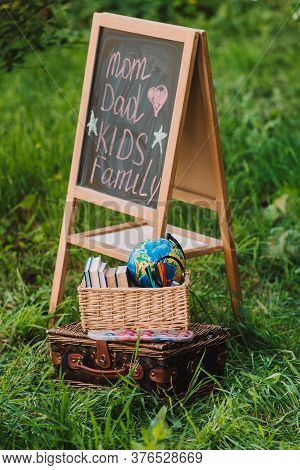 Back To School - School Equipment, Books And Globe With Ukrainian Signature In The Basket. Soft Focu