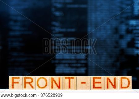 Front End Concept. Wooden Blocks With The Inscription Front-end With Program Code On The Background