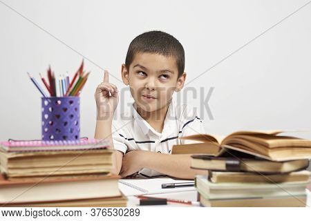 Thoughtful Schoolboy Having Idea, Raising Finger. I Know It. Primary School Pupil Thinking, Creating