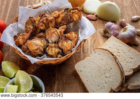 Brazilian Style Deep Fried Chicken And Sliced White Bread. Called Frango A Passarinho