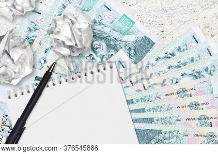 100 Czech Korun Bills And Balls Of Crumpled Paper With Blank Notepad. Bad Ideas Or Less Of Inspirati