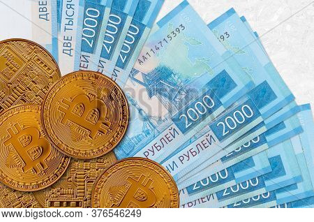 2000 Russian Rubles Bills And Golden Bitcoins. Cryptocurrency Investment Concept. Crypto Mining Or T