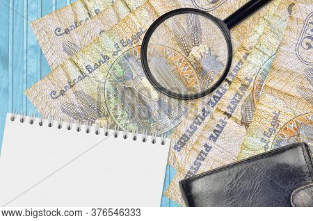 25 Egyptian Piastres Bills And Magnifying Glass With Black Purse And Notepad. Concept Of Counterfeit