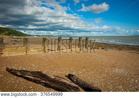 Old Pier Posts In Row On Beach At Low Tide On Tararu Beach Tames New Zealand