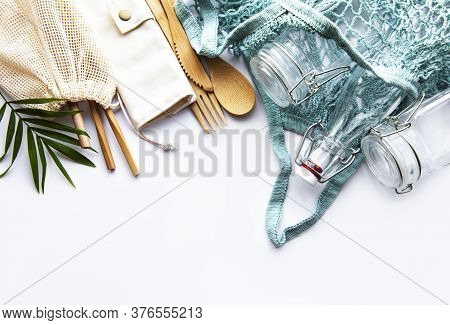 Cotton Bags, Net Bag With Reusable  Glass Jars, Bamboo And Wooden Cutlery On White Background. Zero 