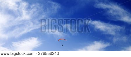 Silhouette Of Skydiver At Windy Sky. Panoramic View.
