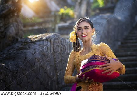 Bali Lady In Traditional Dress Walk In Old Temple, Indonesia