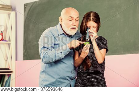 Wisdom. Mature Teacher Look Through Magnifying Glass Tube On Lime. Small Girl Explore Fruit Slice. S