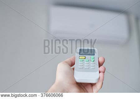 Remote Control For Air Conditioner In Hand. Room Condition Remote Control. Air Temperature Switch Fo