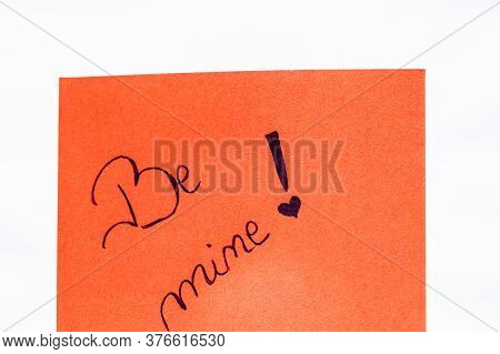 Be Mine Handwriting Text Close Up Isolated On Orange Paper With Copy Space. Writing Text On Memo Pos