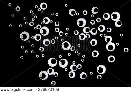 Many Googly Eyes Organized Over Black Background