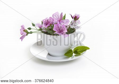 White Cup With Flowers Inside On A White Background