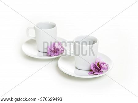 Two White Cup With Flowers On A White Background