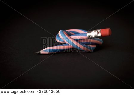 Flexible Pencil On A Dark Background. Selective Focus