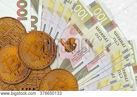 100 Ukrainian Hryvnias Bills And Golden Bitcoins. Cryptocurrency Investment Concept. Crypto Mining O