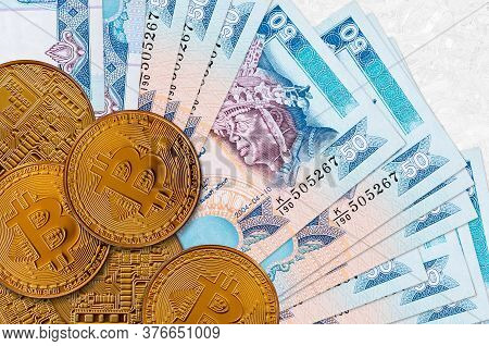 50 Sri Lankan Rupees Bills And Golden Bitcoins. Cryptocurrency Investment Concept. Crypto Mining Or 