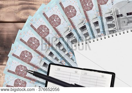 5 Egyptian Pounds Bills Fan And Notepad With Contact Book And Black Pen. Concept Of Financial Planni