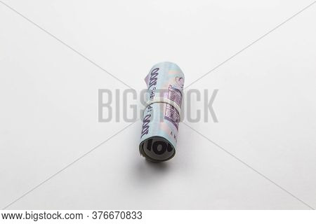 A Roll Of Ukrainian Money. Banknotes Of Ukraine Against White Background.five Thousand Hryvnia With