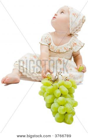 Petite fille mange de gros raisins