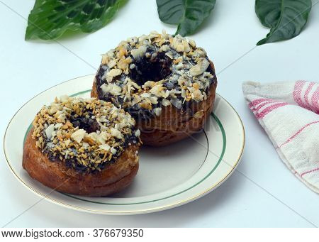 Two Chocolate Donuts With Various Topping. On Whitel Background