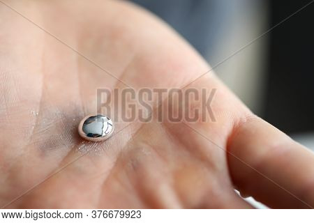 Male Hand Holding Piece Of Liquid Gallium Close-up