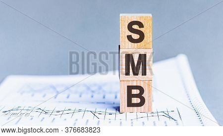 Pile With Three Wooden Cubes - Letters Smb Meaning Small To Medium Sized Business On Them, Space For