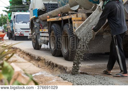 Mixed Concrete Pouring At Construction Site. Pouring Cement During Sidewalk Upgrade. Pour Concrete,p