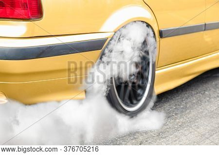 Drag Racing Car Burns Rubber Off Its Tires In Preparation For The Race