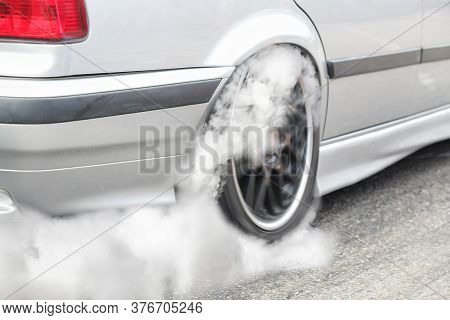 Drag Racing Car Burns Rubber Off Its Tires In Preparation For The Race