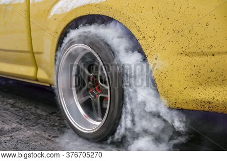 Drag Racing Car Burns Rubber Off Its Tires In Preparation For The Race