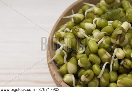 Sprouted Mungbeans In A Wooden Bowl . Macro Shot. Concept Of Microgreen