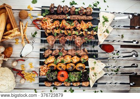 Top View On Assorted Caucasian Skewers Shashlyq Set With Meat And Vegetables