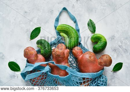 Fresh Ugly Cucumbers And Potatoes On A Concrete Gray Background. Trendy Ugly Vegetables. Imperfect F